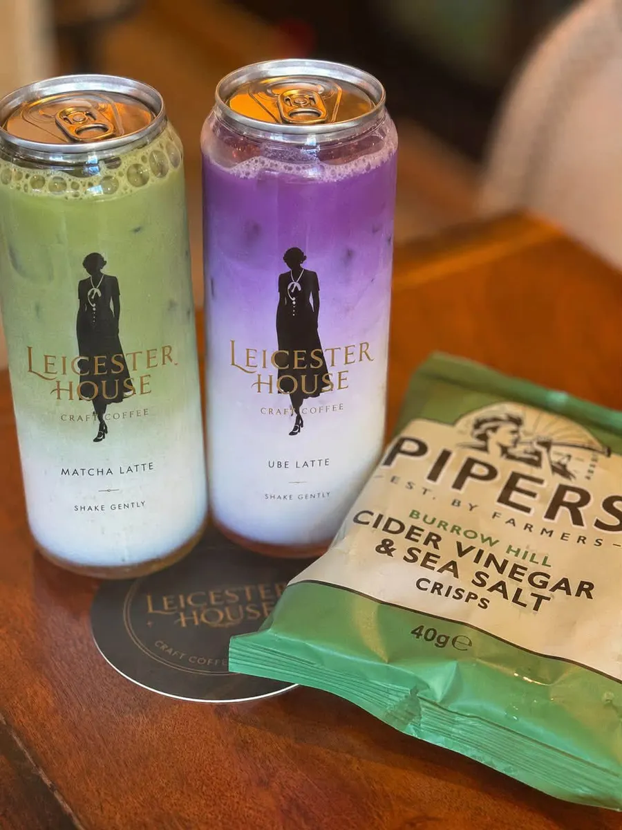 Leicester House matcha and ube lattes in branded cans, with Pipers crisps